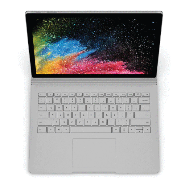 A silver certified refurbished Microsoft Surface Book 2 (13.5" Touch, i5 8350U, 8GB RAM, 256GB SSD, W11P) is shown from above at a wide angle with its keyboard visible and a vibrant abstract design on the screen.